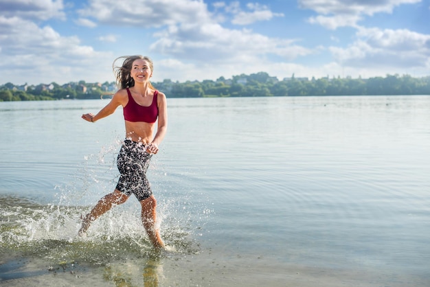 A young girl runs along the shore joyful emotions on summer vacation