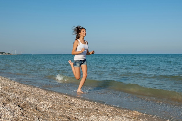 Young girl runs on the sea