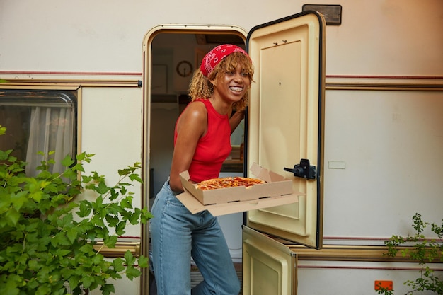 Young girl serving table with pizza