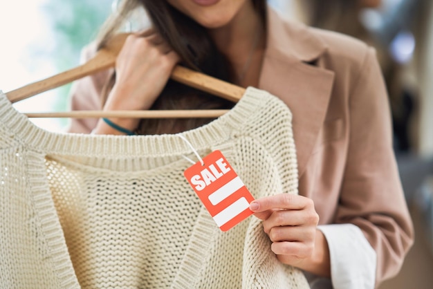 Young girl on shopping during sale holding tag. High quality photo