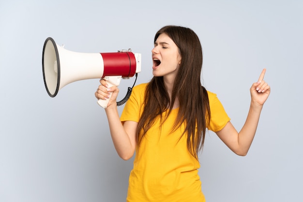 Young girl shouting through a megaphone to announce something in lateral position