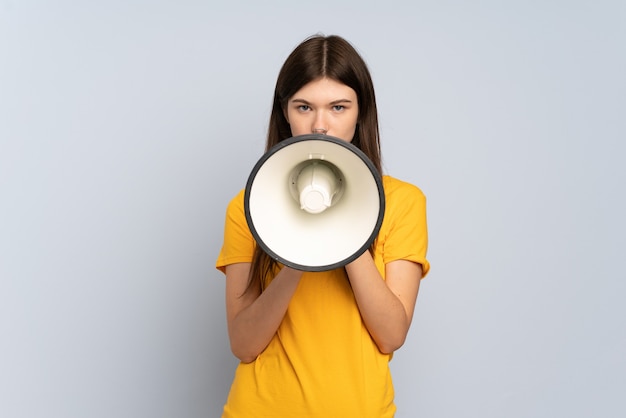 Young girl shouting through a megaphone to announce something