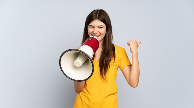 Young girl shouting through a megaphone and pointing side