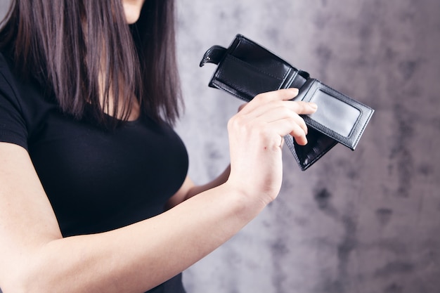 Young girl showing empty wallet