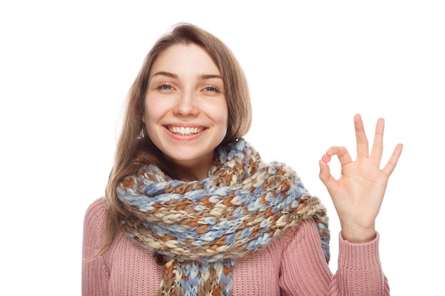 Young girl showing OK gesture