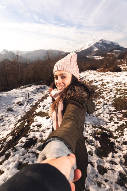 Young girl showing the snowy mountains from the Basque Country