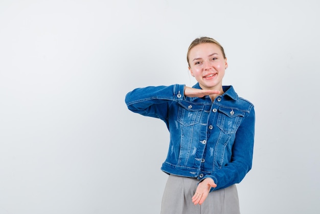 Young girl showing something big hand gesture on white background