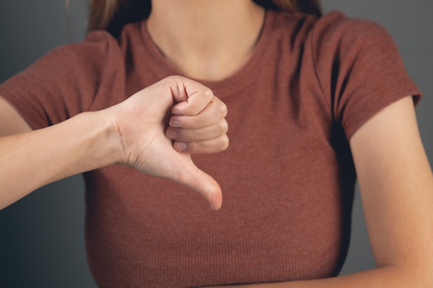 Young girl showing thumb down