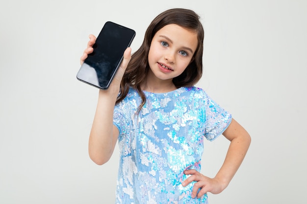 Young girl shows a blank screen with a layout on a white background