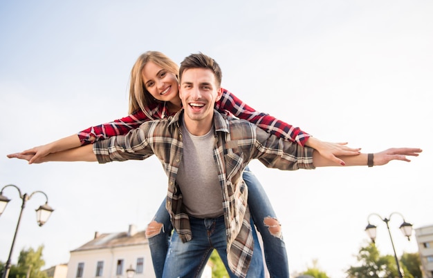 Young girl sits on the shoulders of a man and flies.