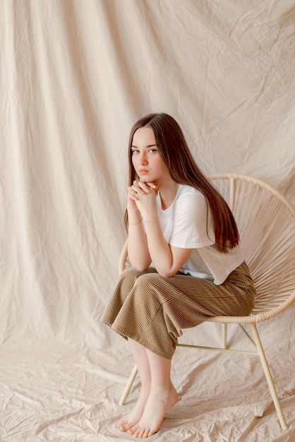 Young girl sitting on a chair