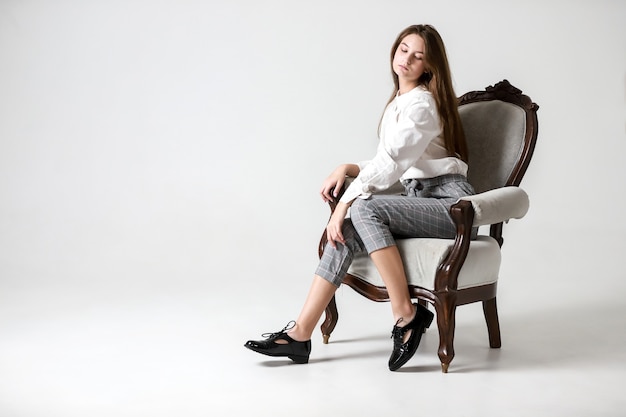 Young girl sitting in a chair