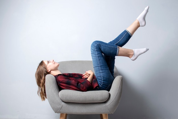 Young girl sitting on a comfortable chair