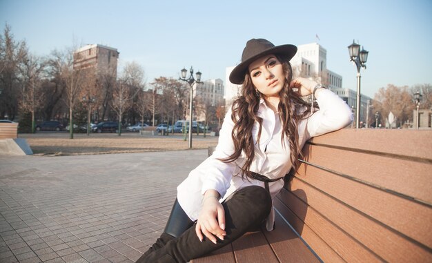 Young girl sitting in the outdoor.