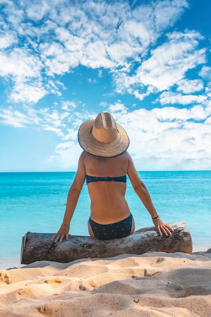 A young girl sitting in the sun on the beach of Punta de Sal, Tela. Honduras