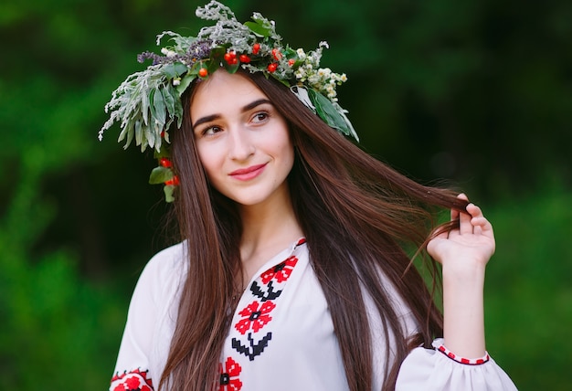 A young girl of Slavic appearance with a wreath of wild flowers on the MidSummer.