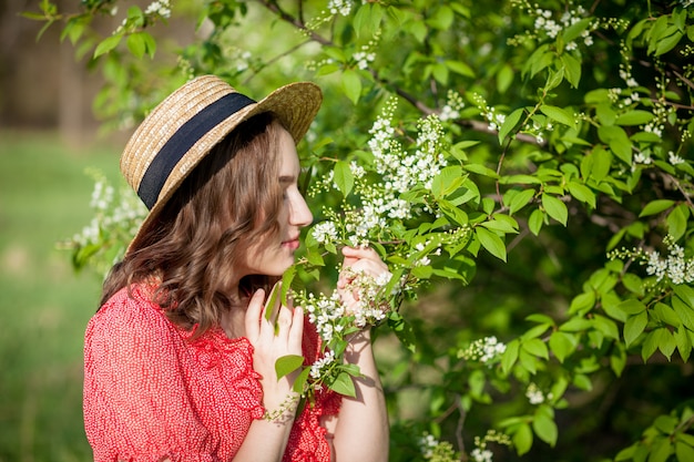 Young girl smelling a blooming tree