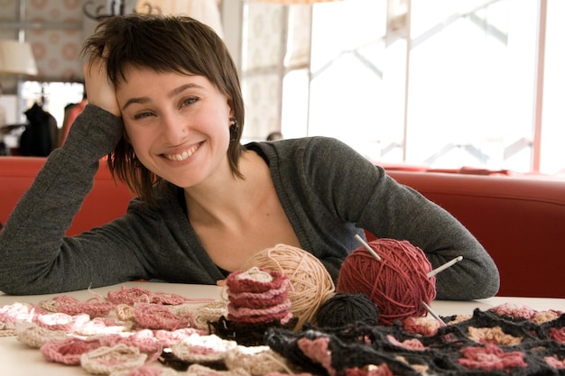 Young girl smiling and crochet scarf with flowers