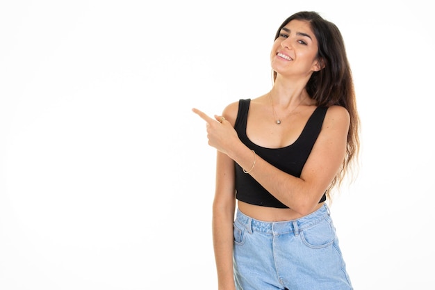 Young girl smiling woman standing and pointing finger up side copy space