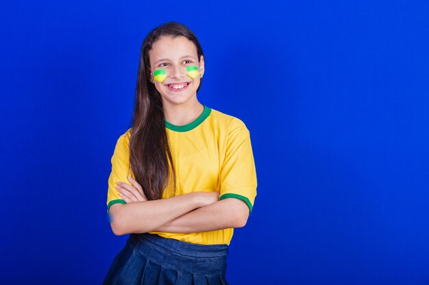 Young girl soccer fan from brazil crossed arms