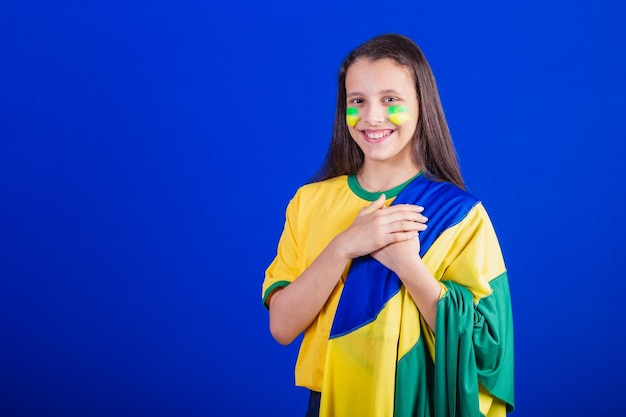 Young girl soccer fan from Brazil dressed in flag singing national anthem Gratitude