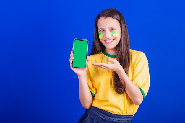 Young girl soccer fan from Brazil holding cellphone screen for advertisement promotion Smartphone applications