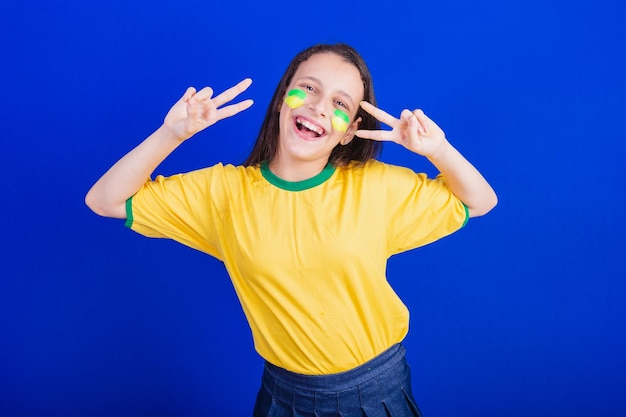 Young girl soccer fan from brazil sign of peace and love good vibrations