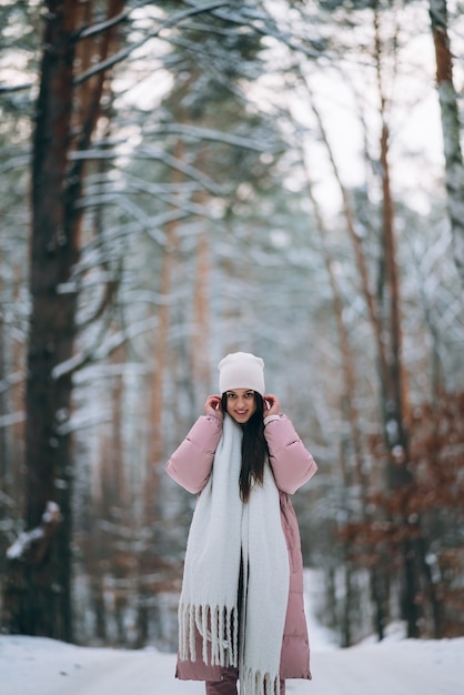 Young girl standing in the middle of snowy road