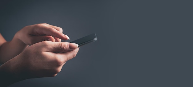 A young girl stands with a phone in her hands