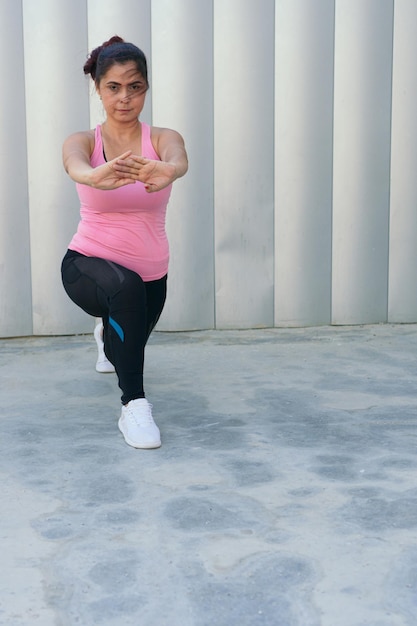 A young girl stretches during a street run