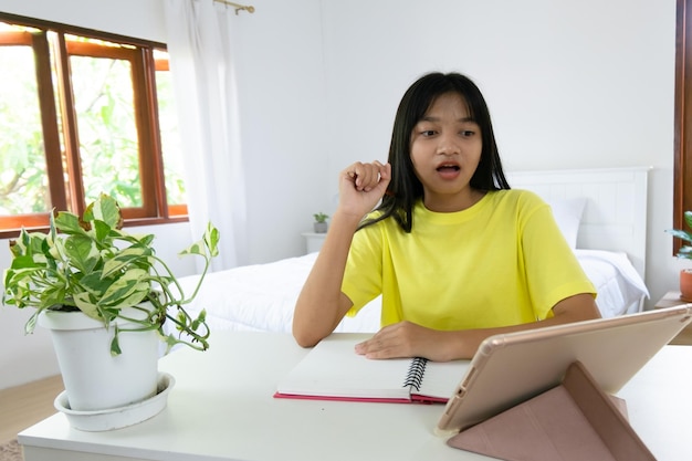 Young girl studying at home student girl doing homework in bedroom at home