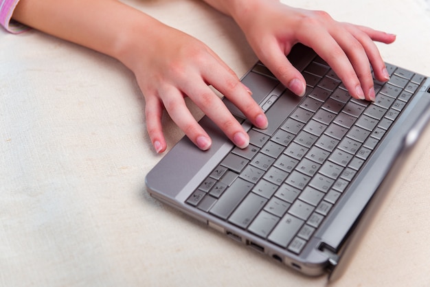 Young girl surfing internet on laptop