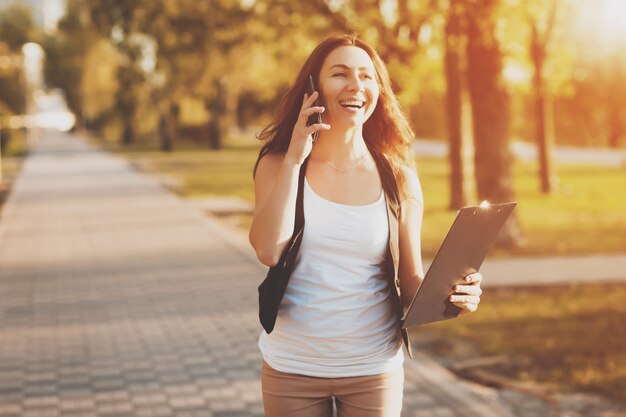 Young girl talking on a cell phone in the park