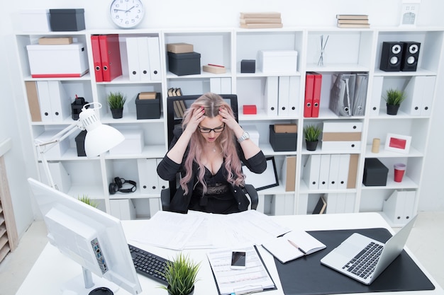 Foto giovane ragazza stanca dopo una lunga giornata in ufficio