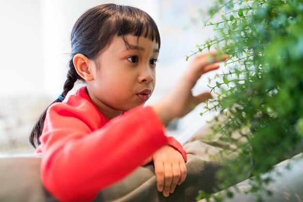Young girl touching plant