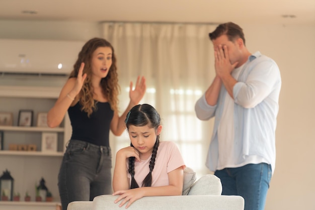 Young girl trapped in the middle of tension by her parent argument synchronos