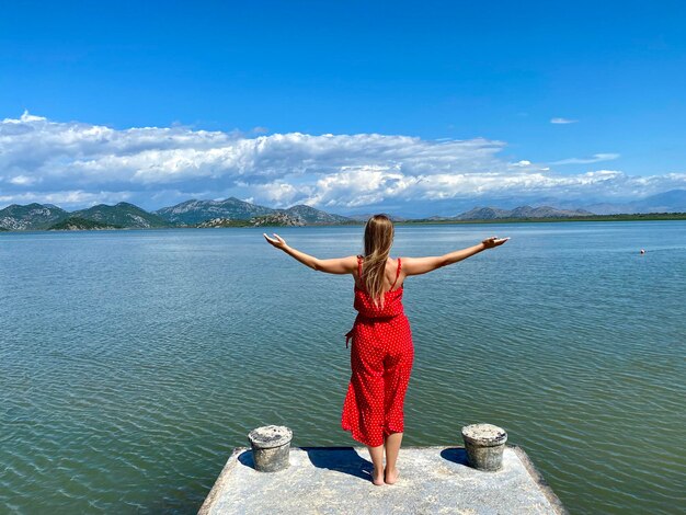 Young girl in a trendy red clothes enjoying the beauty of nature, relaxing,