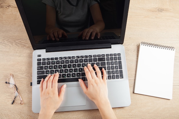 Young girl typing on laptop