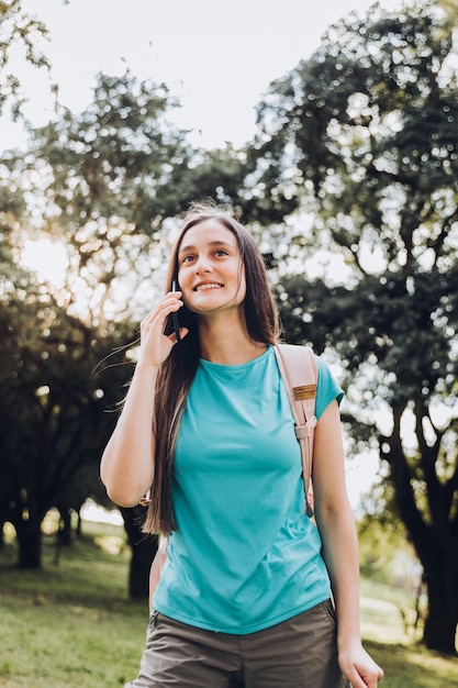 Young girl using her phone to make a call. Communication with relatives and loved ones.