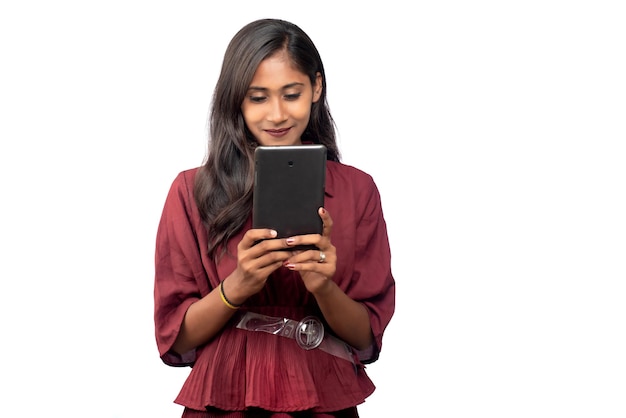 Young girl using mobile phone or smartphone on a white background