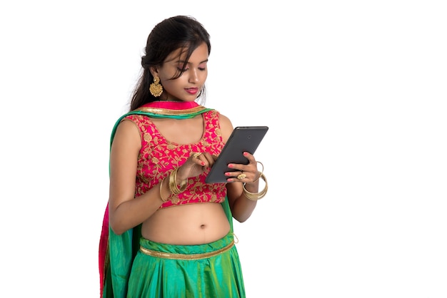 Young girl using mobile phone or smartphone on white