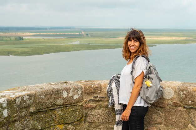 A young girl visiting the famous Mont Saint-Michel Abbey from inside, in the Manche department, Normandy region, France