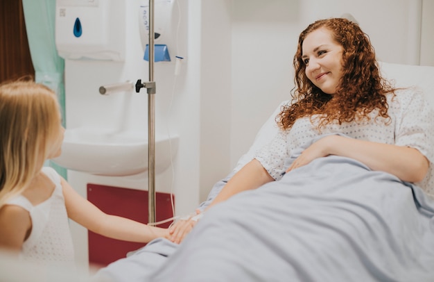 Young girl visiting her mother in the hospital