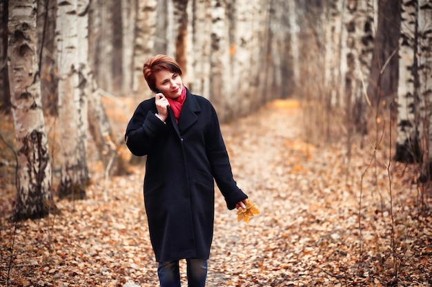 Young girl on a walk in the autumn garden