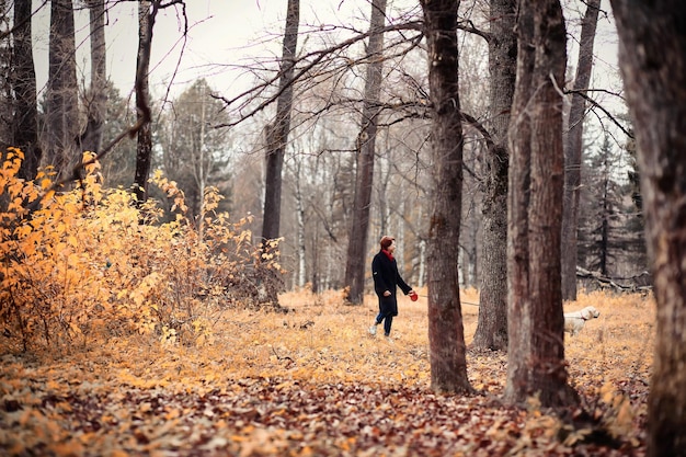 Young girl on a walk in the autumn garden