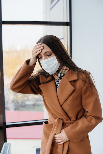 A young girl walks in a mask during the pandemic and coronovirus. Quarantine