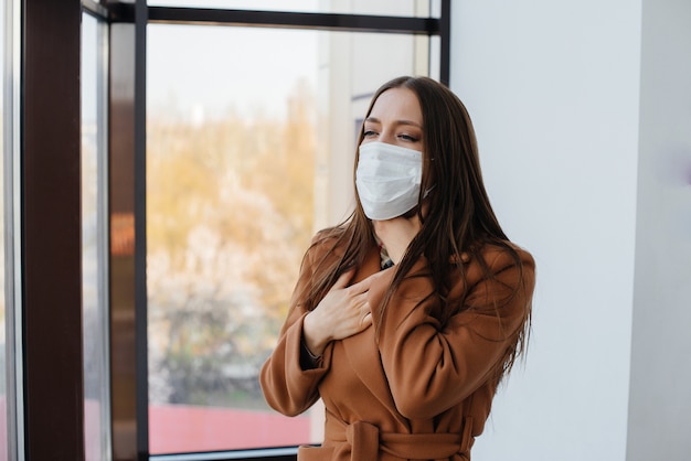 A young girl walks in a mask during the pandemic and coronovirus. Quarantine.