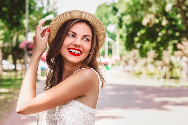 A young girl walks in the park and smiles