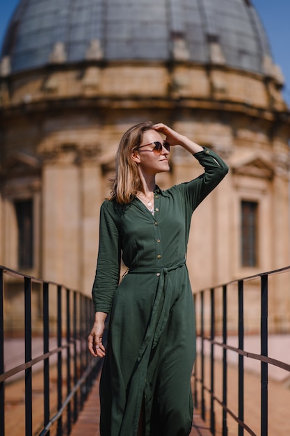 Young girl on the wall of Italian architecture