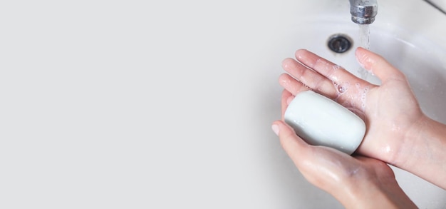 Young girl washing hands with a soap Hygiene